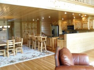 Whispering Pines projects light log home interior dining and kitchen with countertop bar