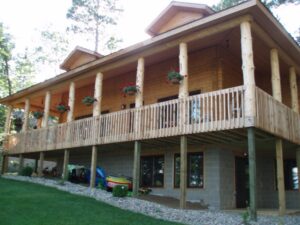 Whispering Pines projects two story log home exterior porch view