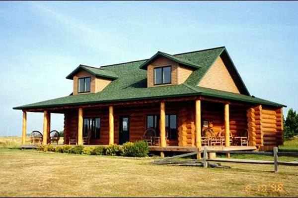 Exterior of Lodgepole style log home with large porch.
